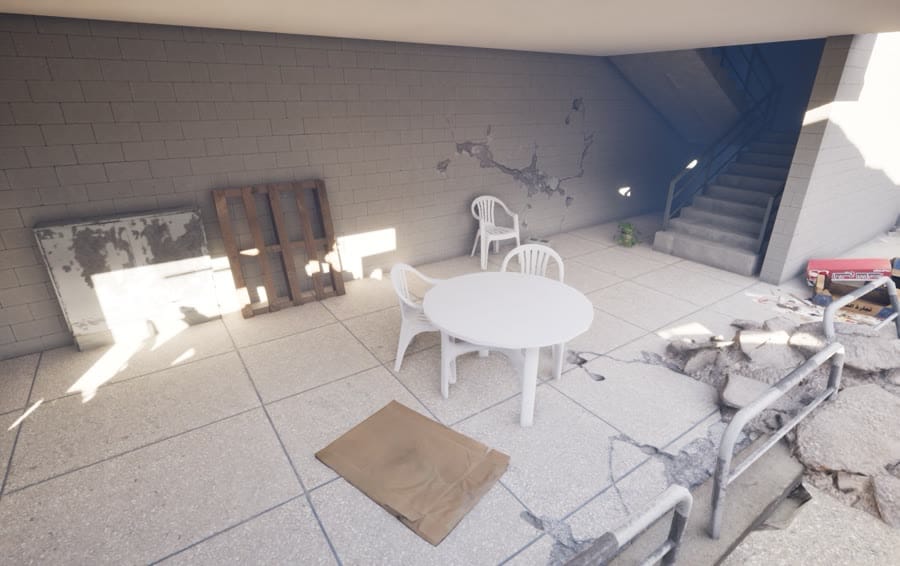 Mission 2, the courtyard: an outside staircase, plastic chairs and broken paving