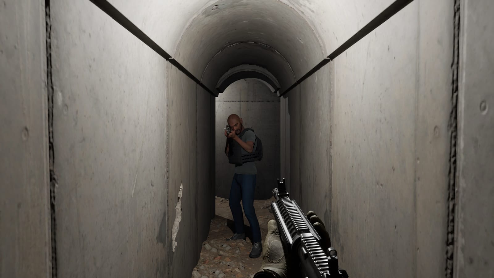 In a concrete tunnel, an enemy in a plate carrier aims his rifle straight at the soldier, whose gloved hands grip the M4 in the foreground